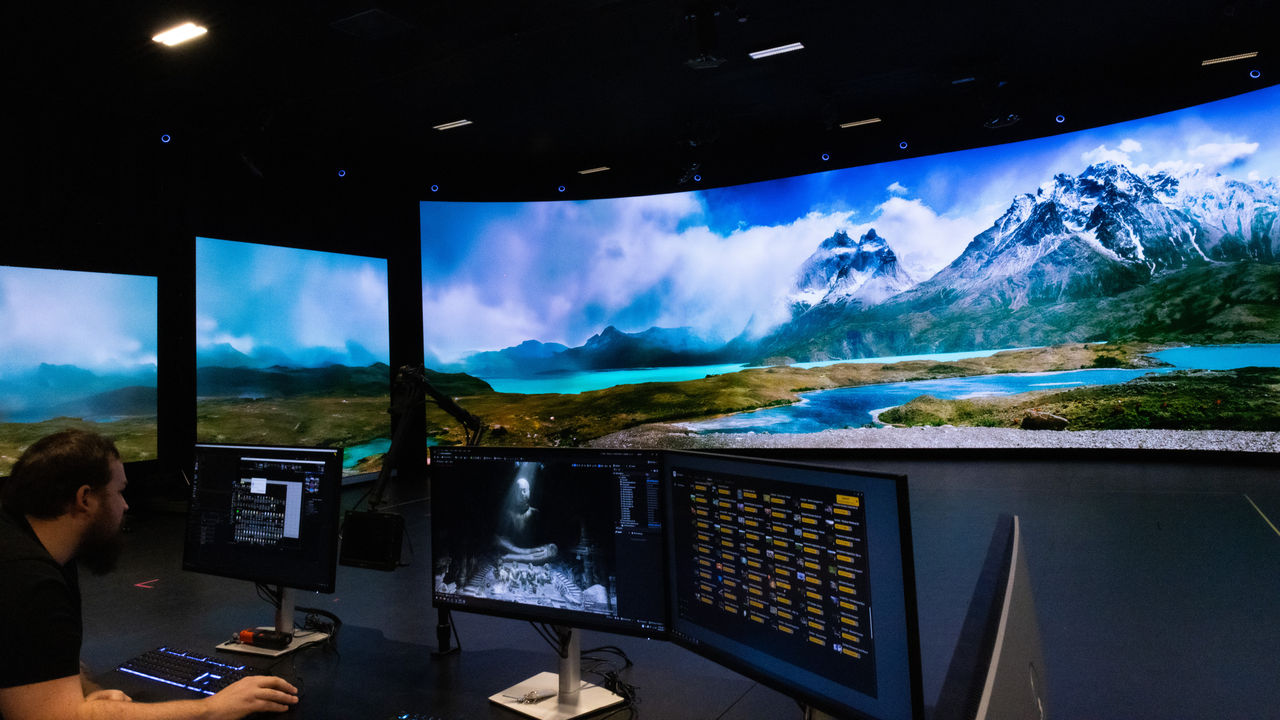 Image of a studio technician working on a screen to project an image of mountains onto the virtual production screen at Kōawa Studios.