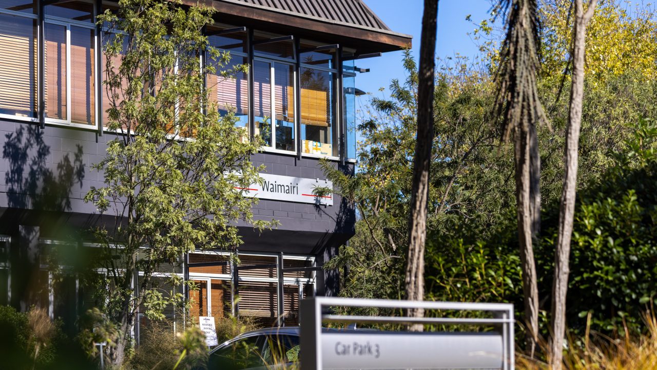 An exterior image where the Waimairi building is seen through the trees
