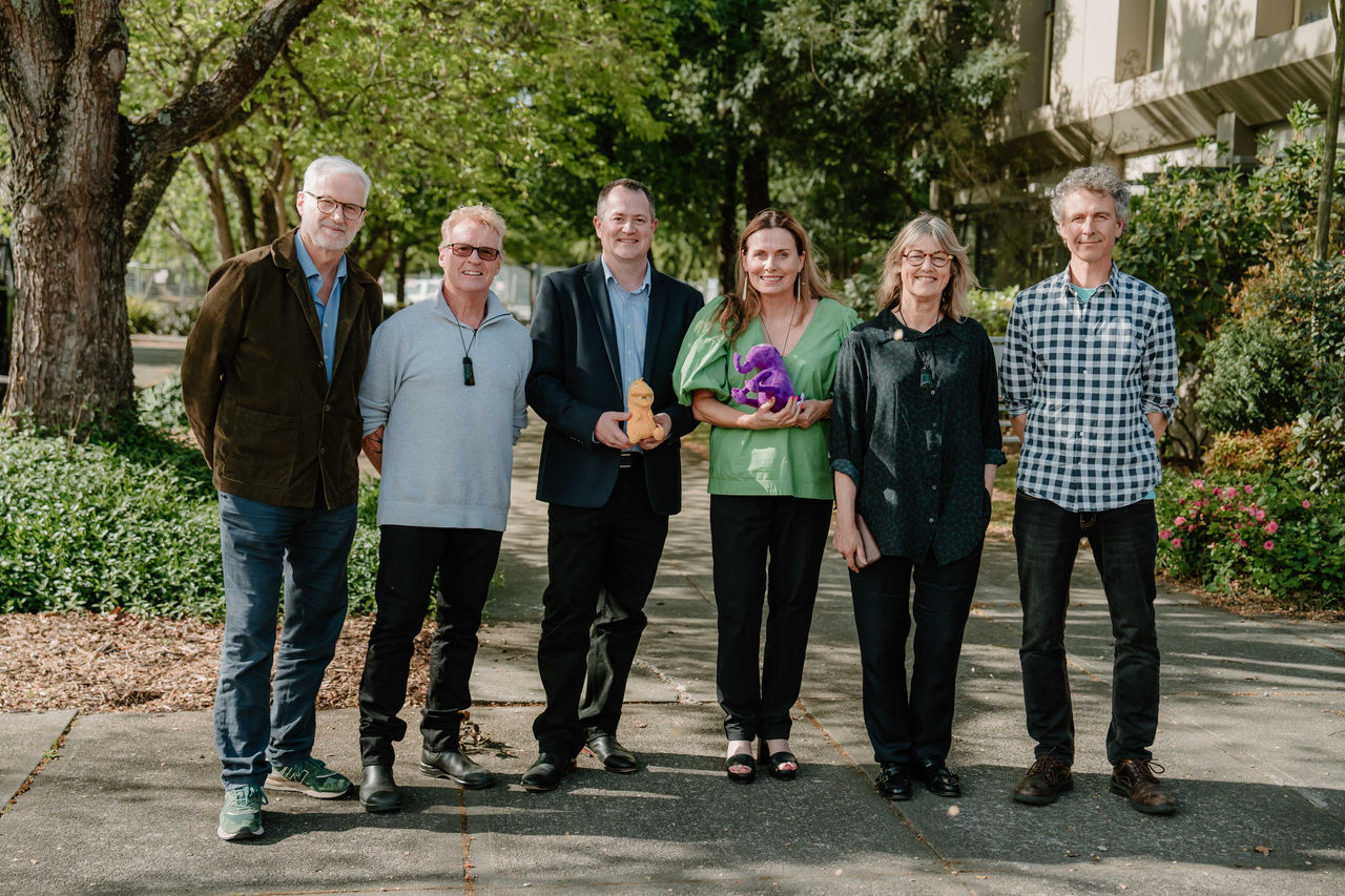 Image of staff from Stretchy Productions with University of Canterbury's Executive Dean of Arts Kevin Watson, and Kōawa Studios Director, Sam Witters.